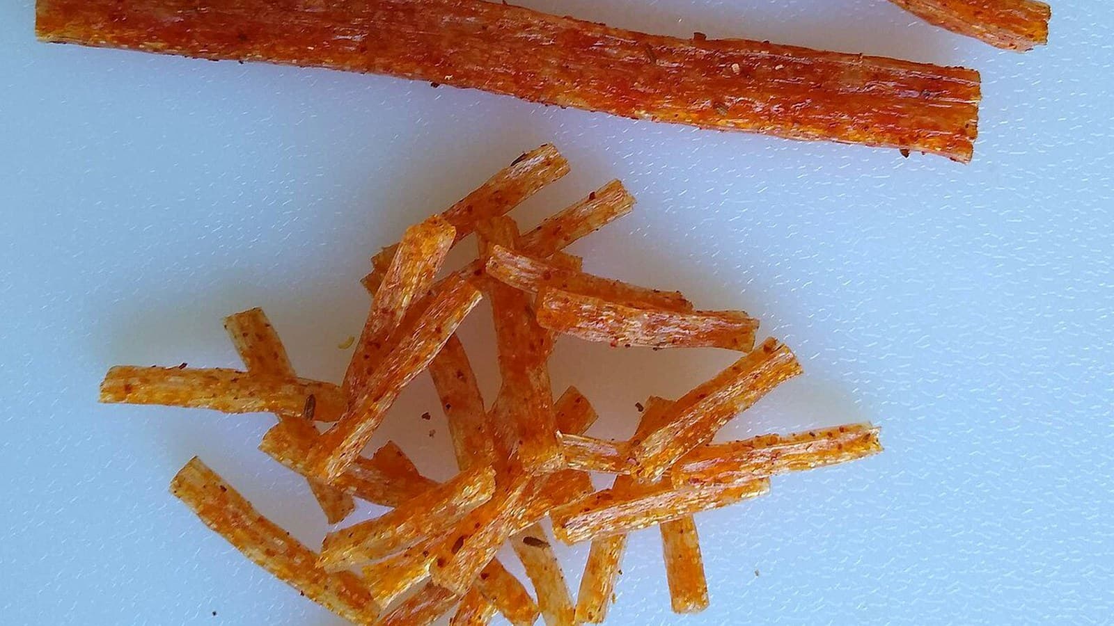 A finished spicy strip sample used to show the bean-route product after seasoning