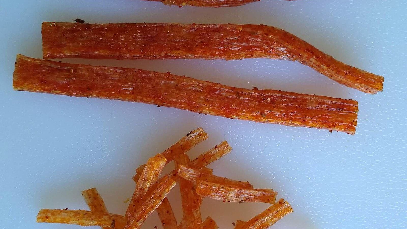 A bowl of chili oil with dried chilies and spices