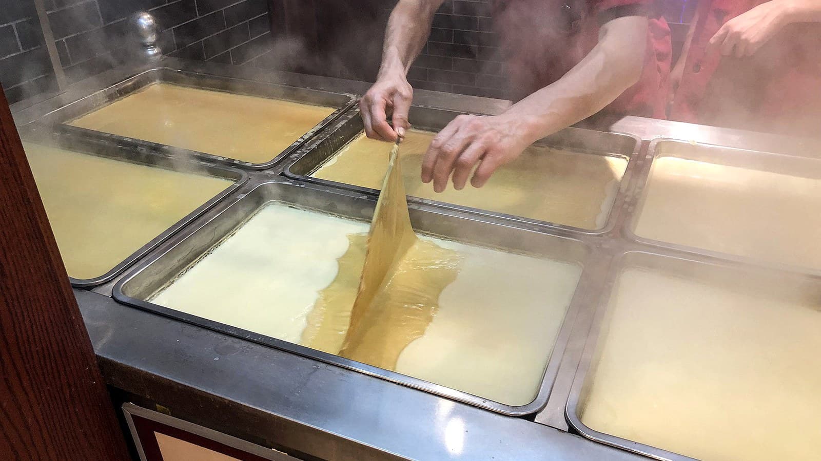 A tofu skin processing station used to compare line configurations and working steps