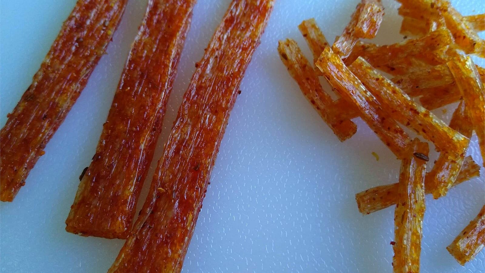 Glossy red latiao strips and smaller cut pieces shown up close on a light background