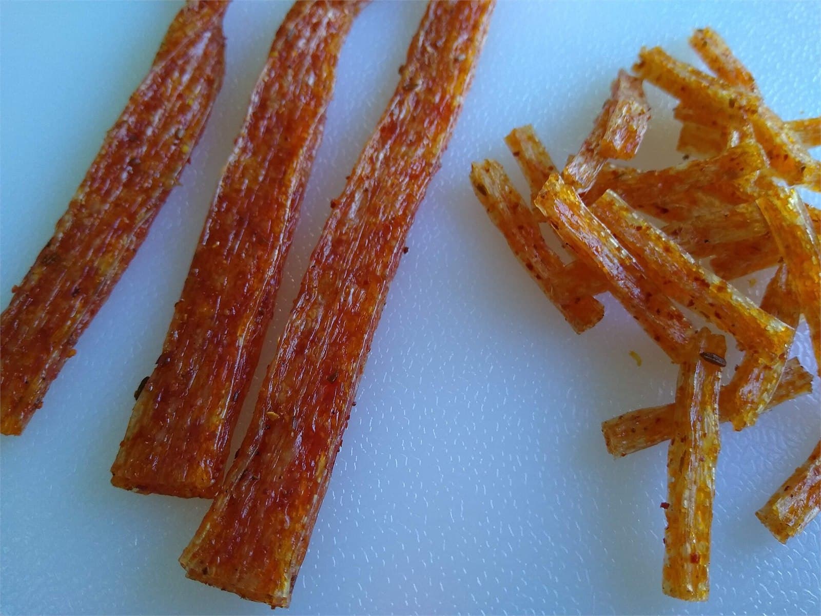 Glossy red latiao strips with visible chili oil and seasoning